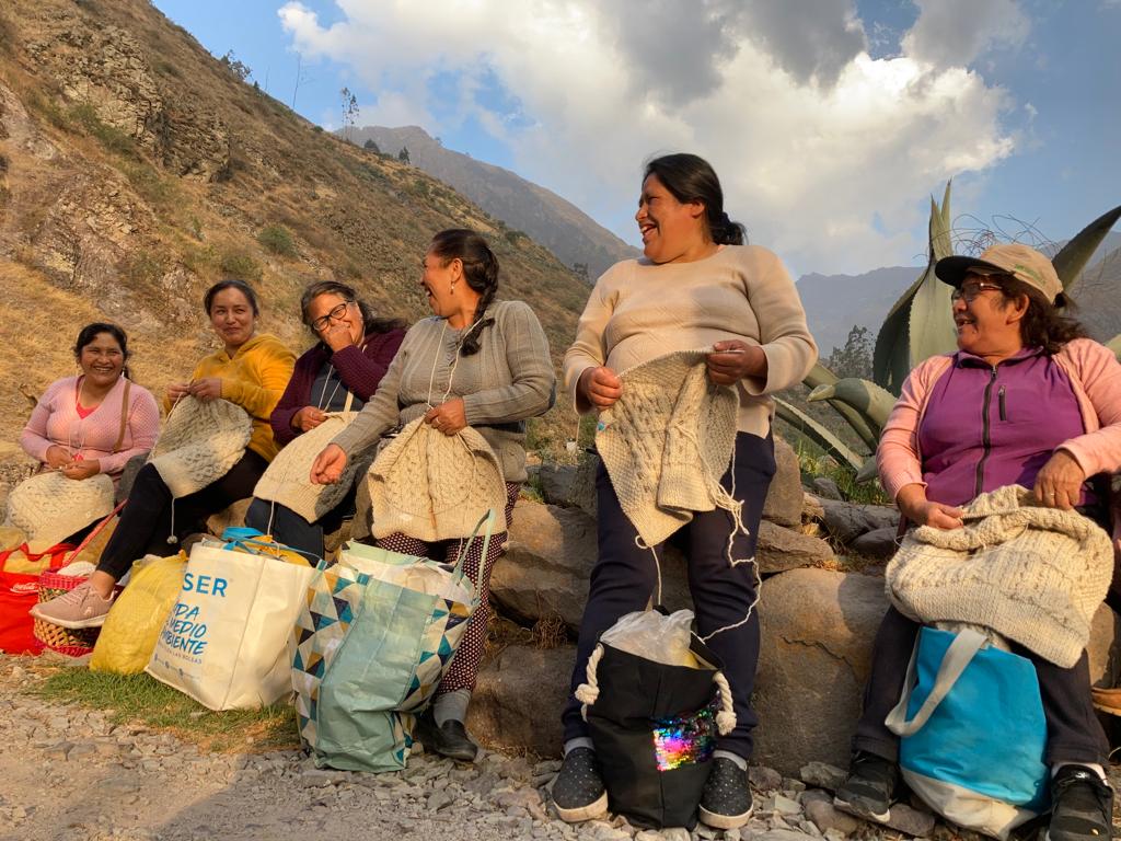 Knitters working outside in Equador making hand-knit jumpers